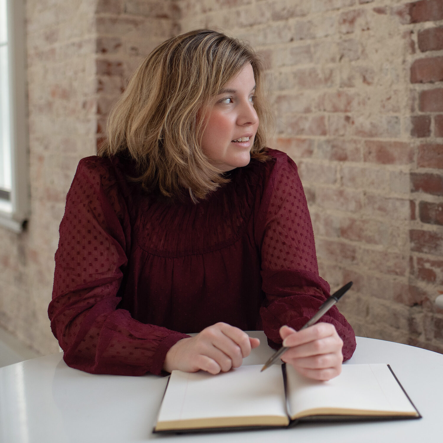 Danielle C Levy Sitting At Table With Planner